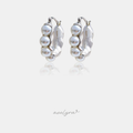 Silver-tone hoop earrings lined with rows of white pearls.