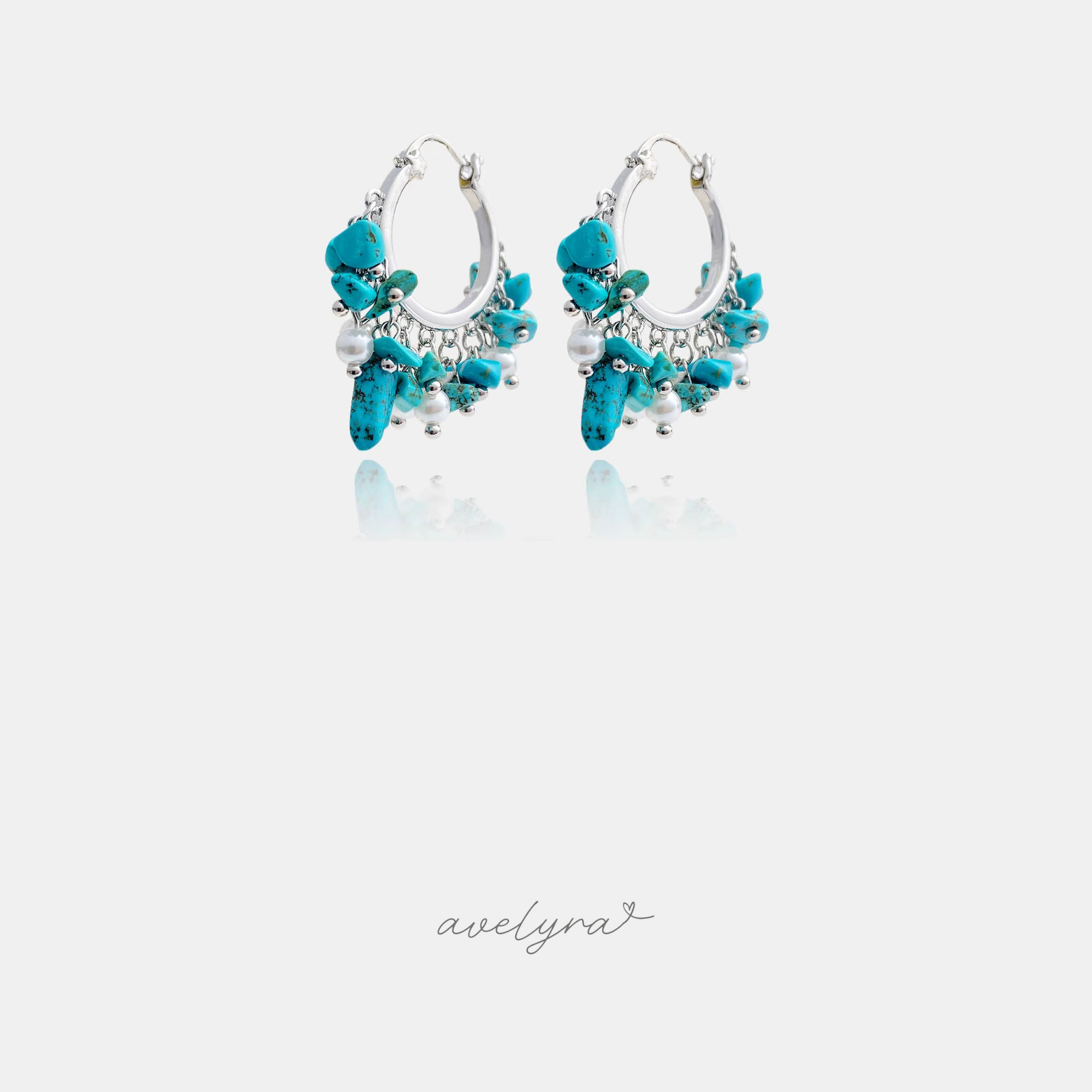Silver-tone hoop earrings clustered with turquoise stone chips and white pearls.
