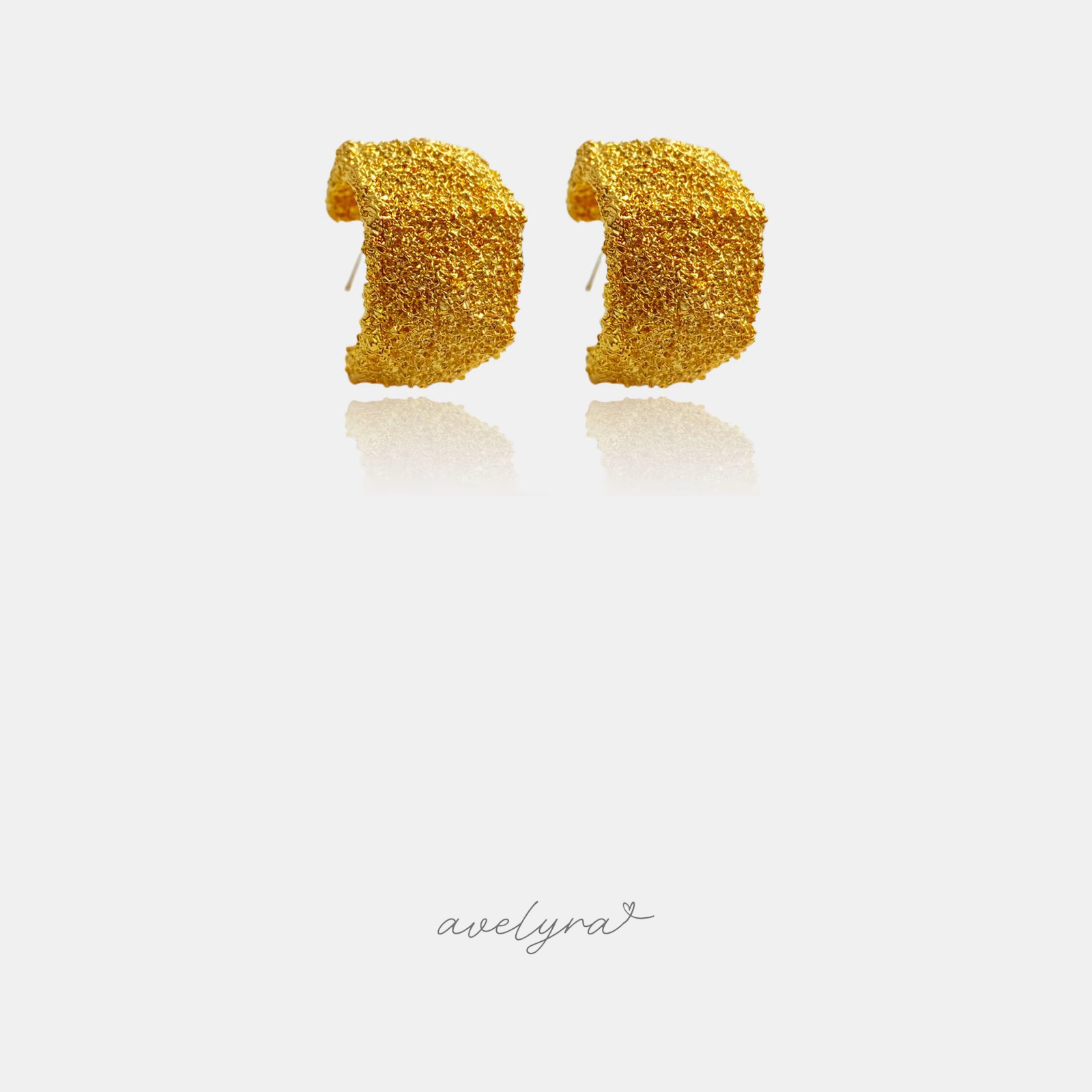 Wide gold-tone hoop earrings with a textured woven surface.