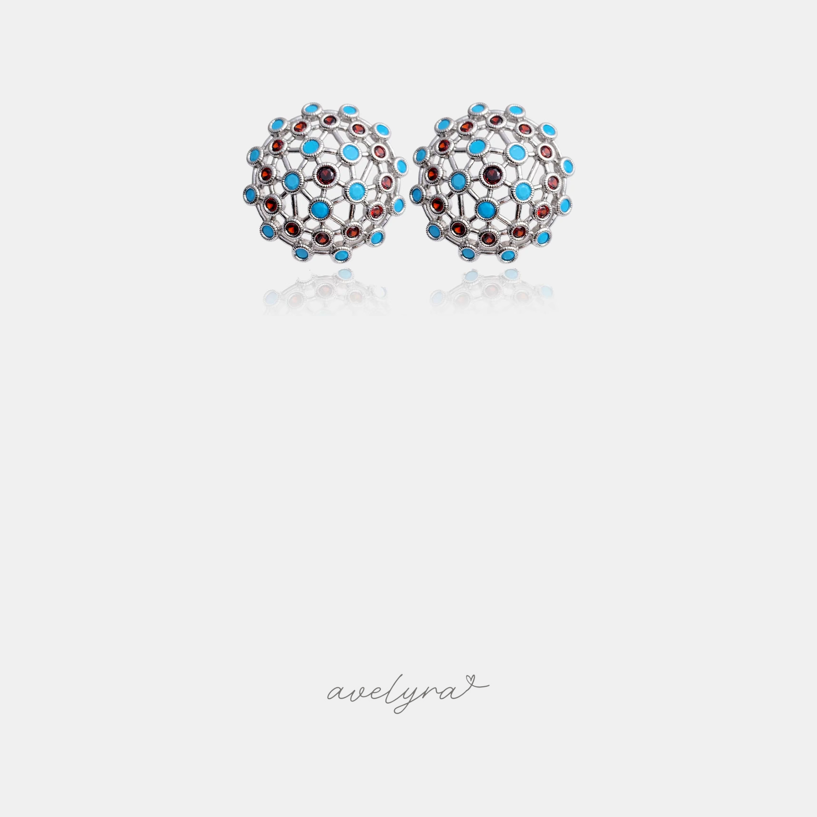 Silver-tone openwork dome stud earrings with blue and red stones.