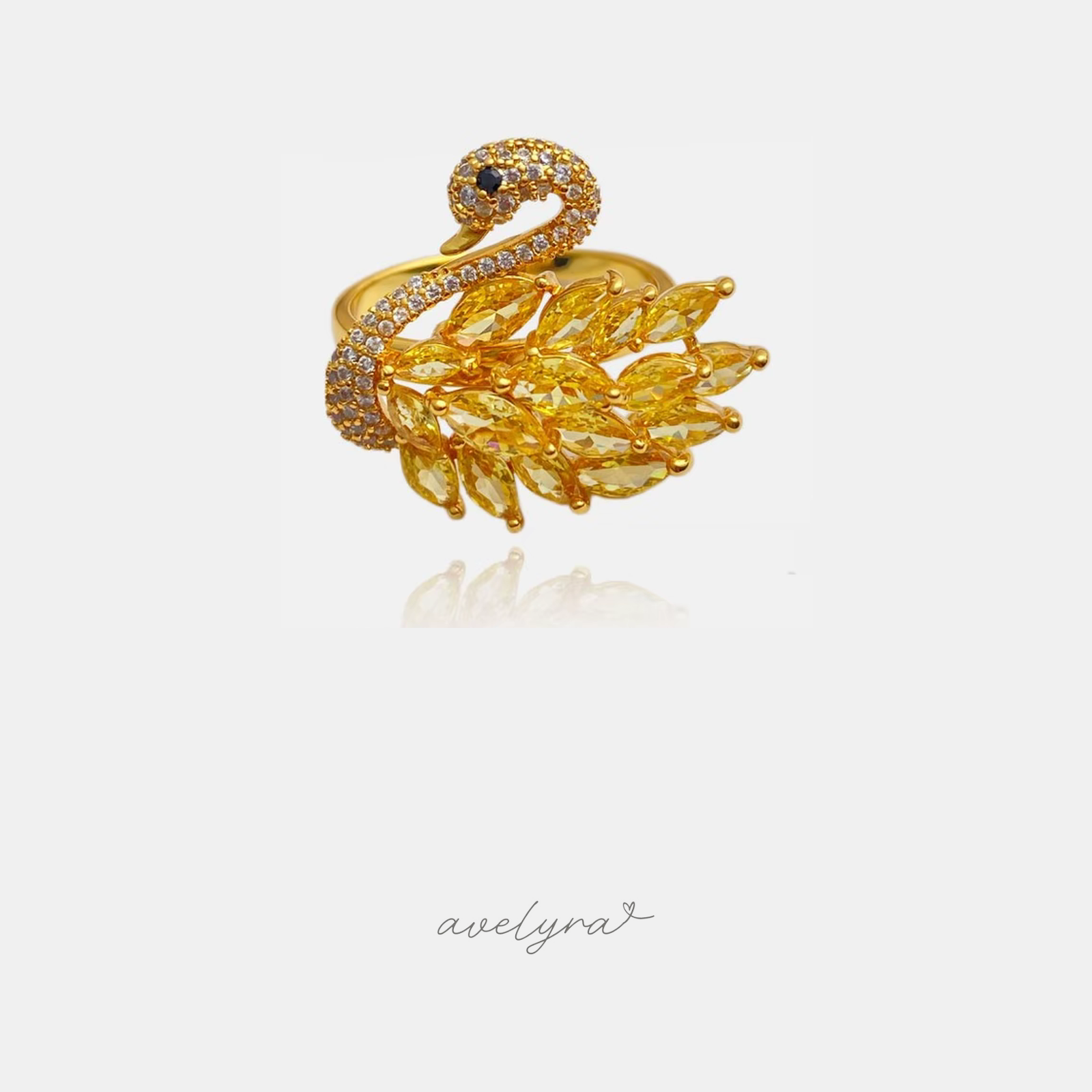 Gold-tone swan-shaped ring with yellow marquise stone wing feathers and a pave-set neck