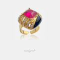 Gold-tone statement ring with a large fuchsia emerald-cut crystal, black enamel panel and rows of clear stones
