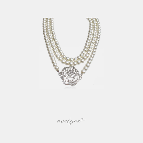 Multi-strand ivory pearl necklace with a large silver-tone crystal-paved rose flower centrepiece.