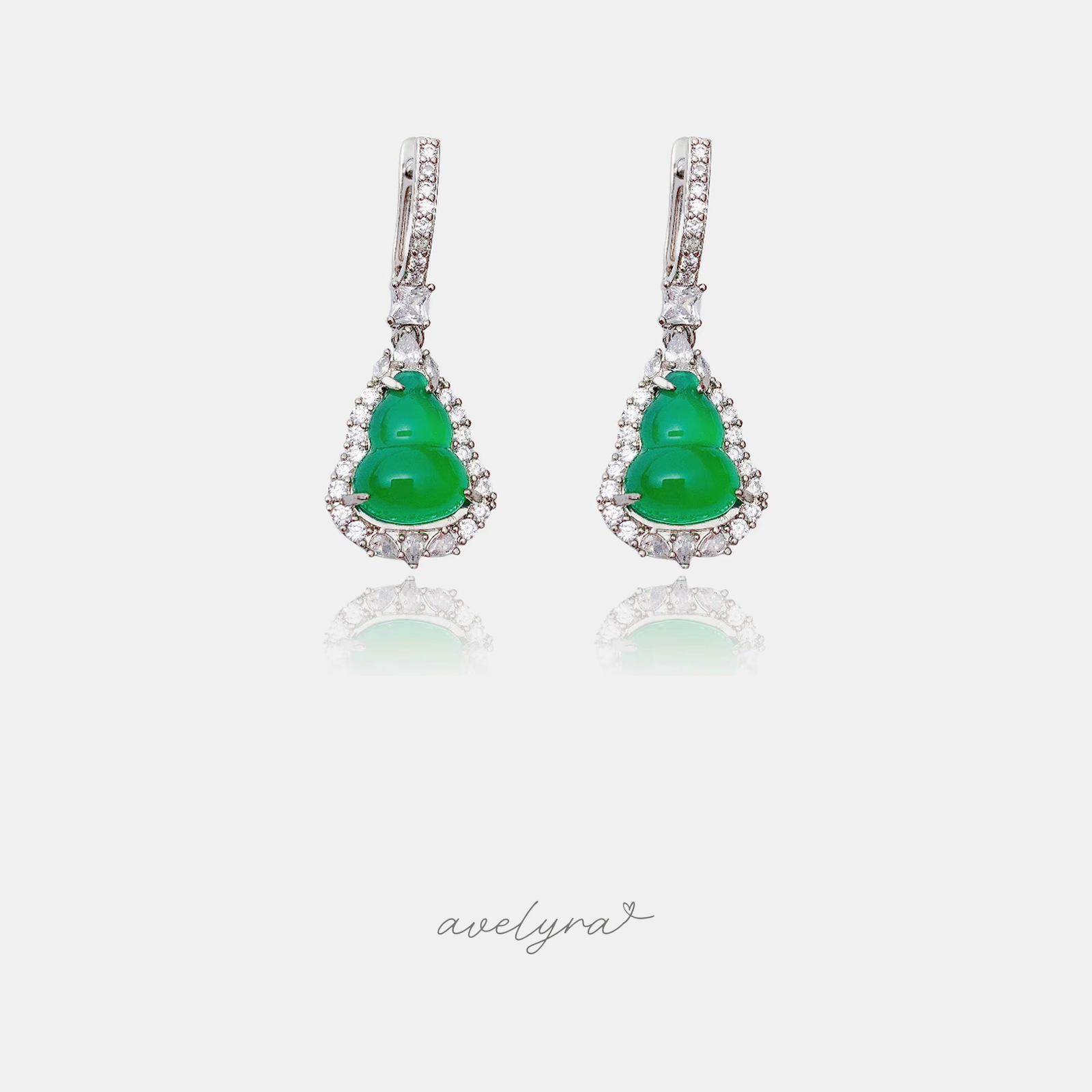 Drop earrings with smooth green gourd-shaped stones outlined by clear crystals, hung from pave hooks.