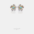 Floral stud earrings with pave white petals, golden stamens and a light blue center stone.