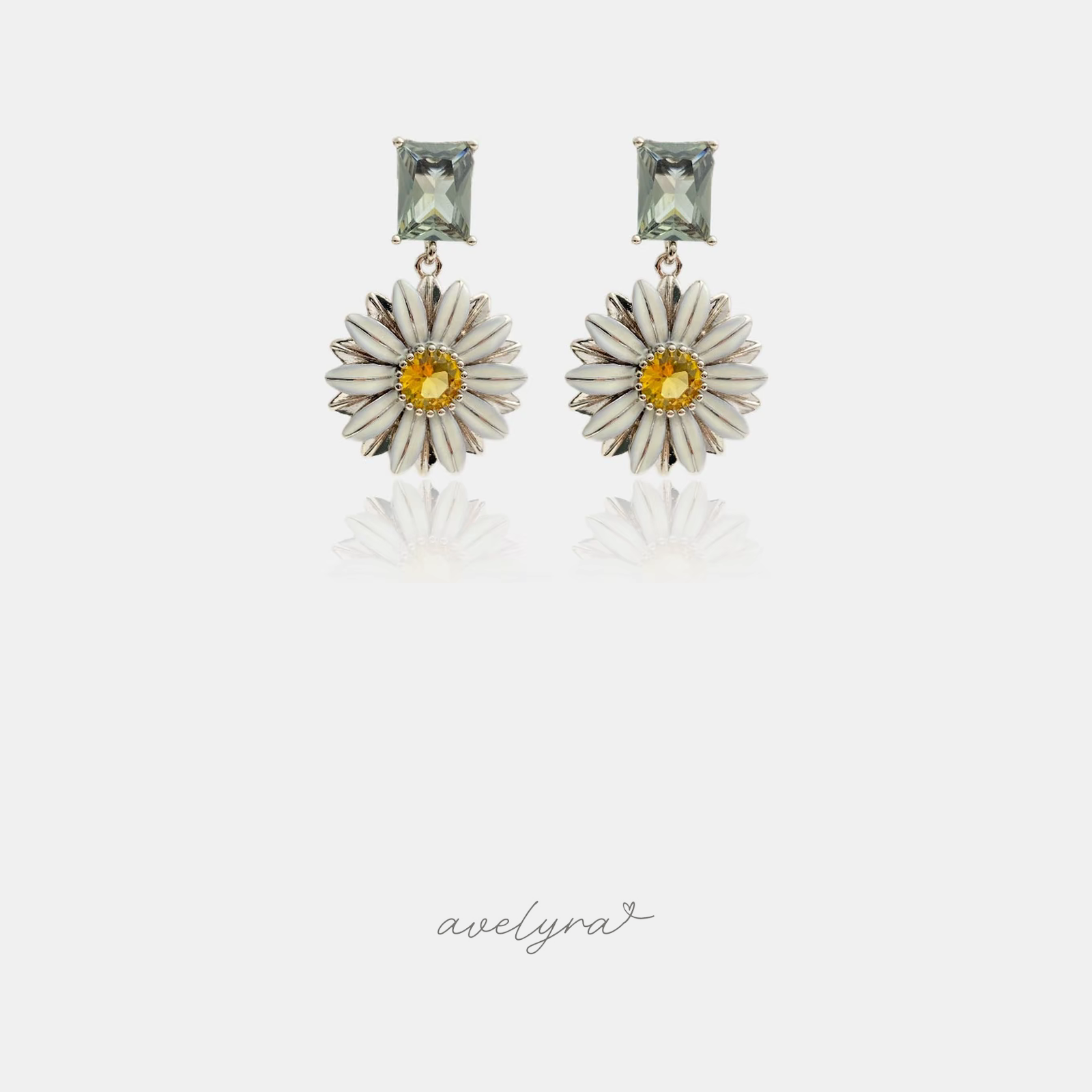 Drop earrings with a rectangular green-grey stone above an ivory daisy flower with a yellow centre.