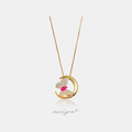 Gold crescent moon pendant with a pave butterfly and pink marquise stone on a thin chain.