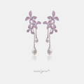 Silver-tone earrings with pink pave crystal flowers and two chains ending in white teardrop pearls.