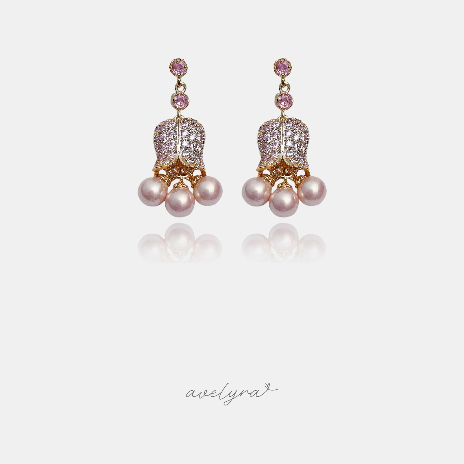 Rose gold-tone drop earrings with pink pave tulip-shaped flowers above clusters of pink pearls.