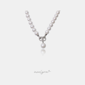 White pearl necklace with silver interlocking pave rings and a hanging pearl drop.