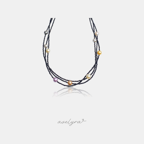 Multi-strand black beaded necklace with scattered pearls in grey, gold, cream, peach and lavender.