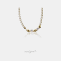 Pearl necklace with gold mariner links and two round clear stones at the centre.