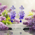 Drop earrings shaped as a cluster of lilac and violet blossoms with a deep blue droplet