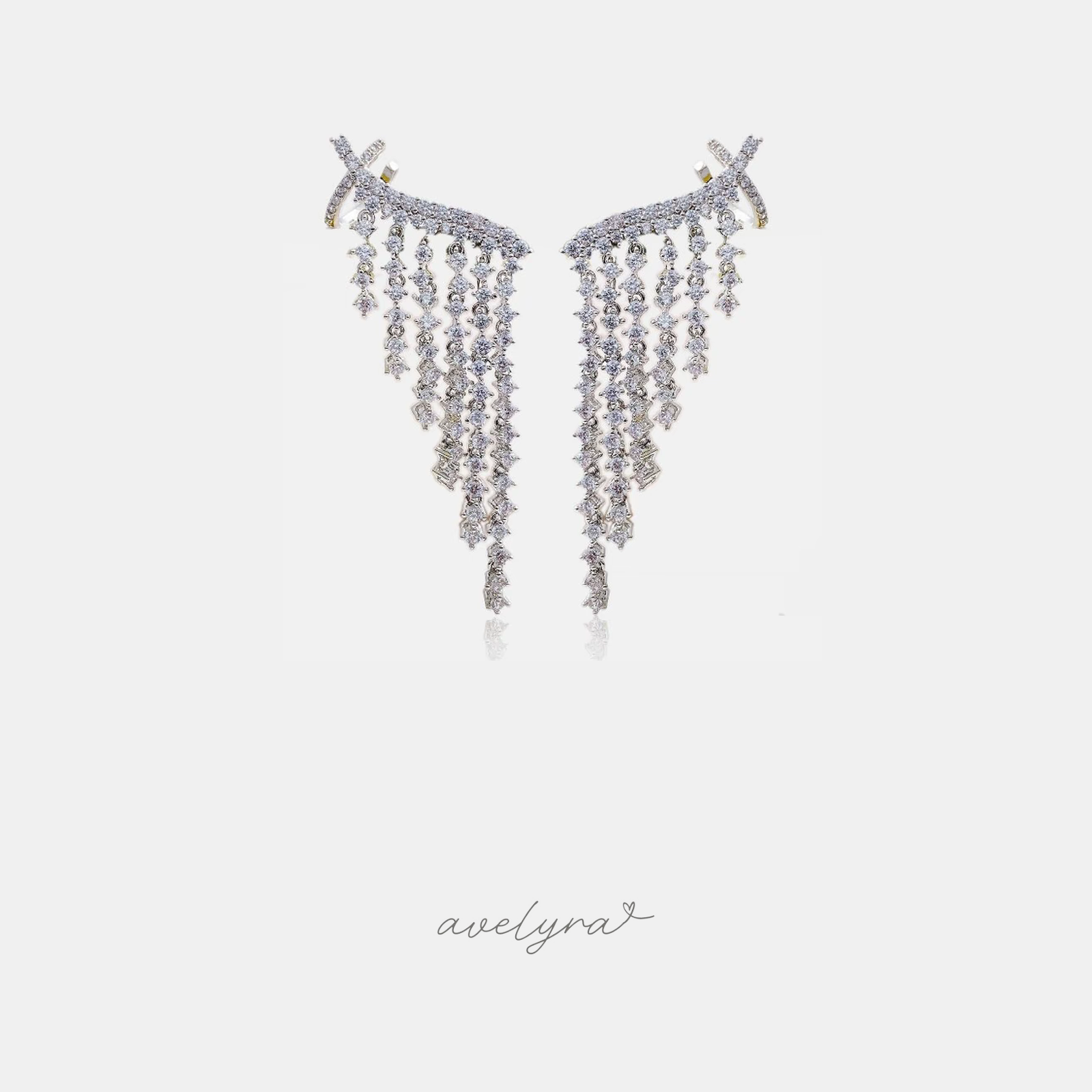 Silver-tone climbing earrings with dense clear crystals arranged in graduated fringe that tapers to a point.