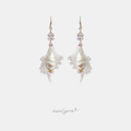Gold-hook drop earrings with a large ivory baroque pearl surrounded by a fan of clear beaded crystals and pink accents.