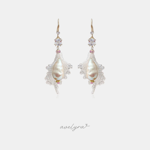 Gold-hook drop earrings with a large ivory baroque pearl surrounded by a fan of clear beaded crystals and pink accents.