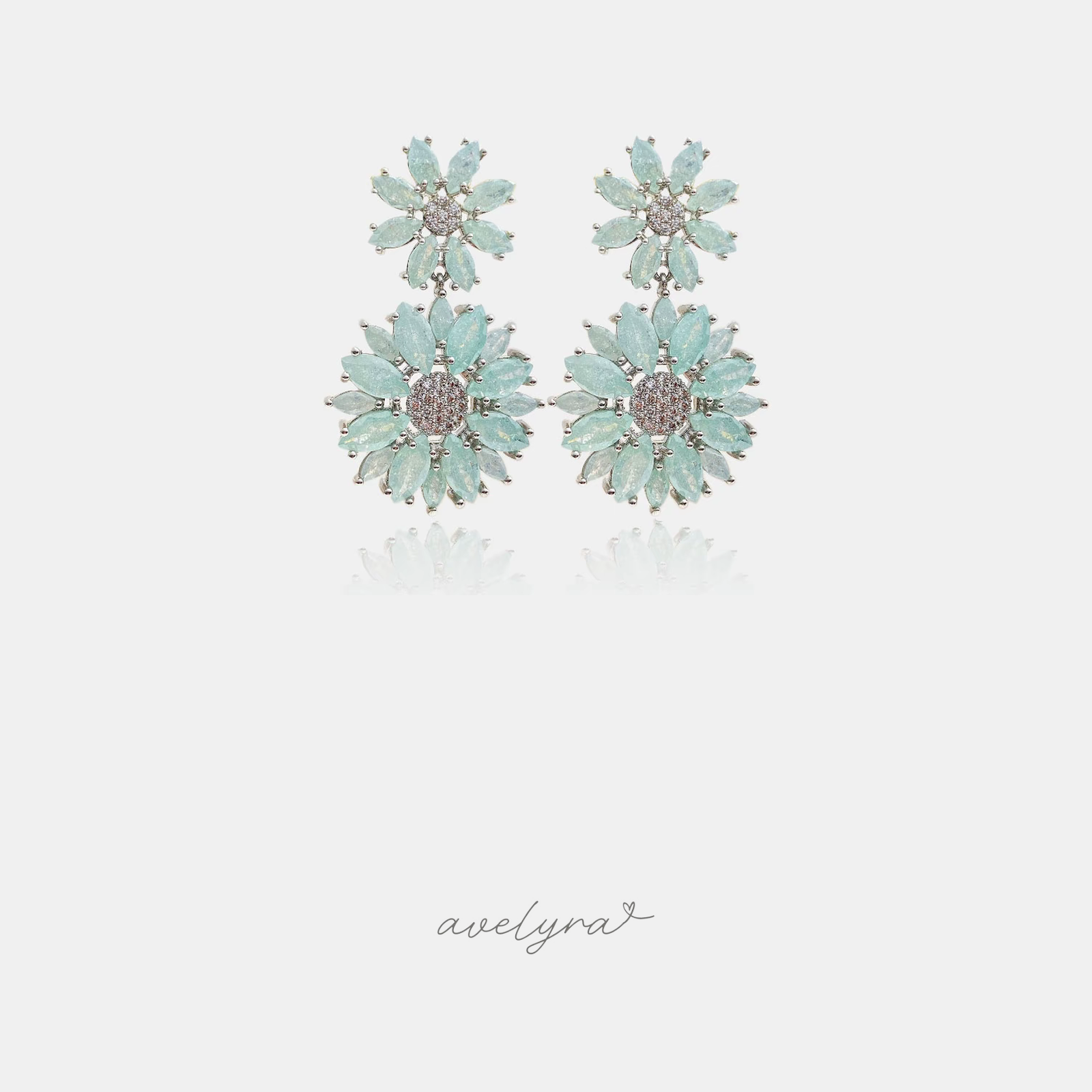 Silver-tone drop earrings with two mint-green flowers, each with marquise petals around a pave crystal center.