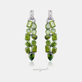 Pair of long drop earrings clustered with faceted olive-green stones in mixed shapes.
