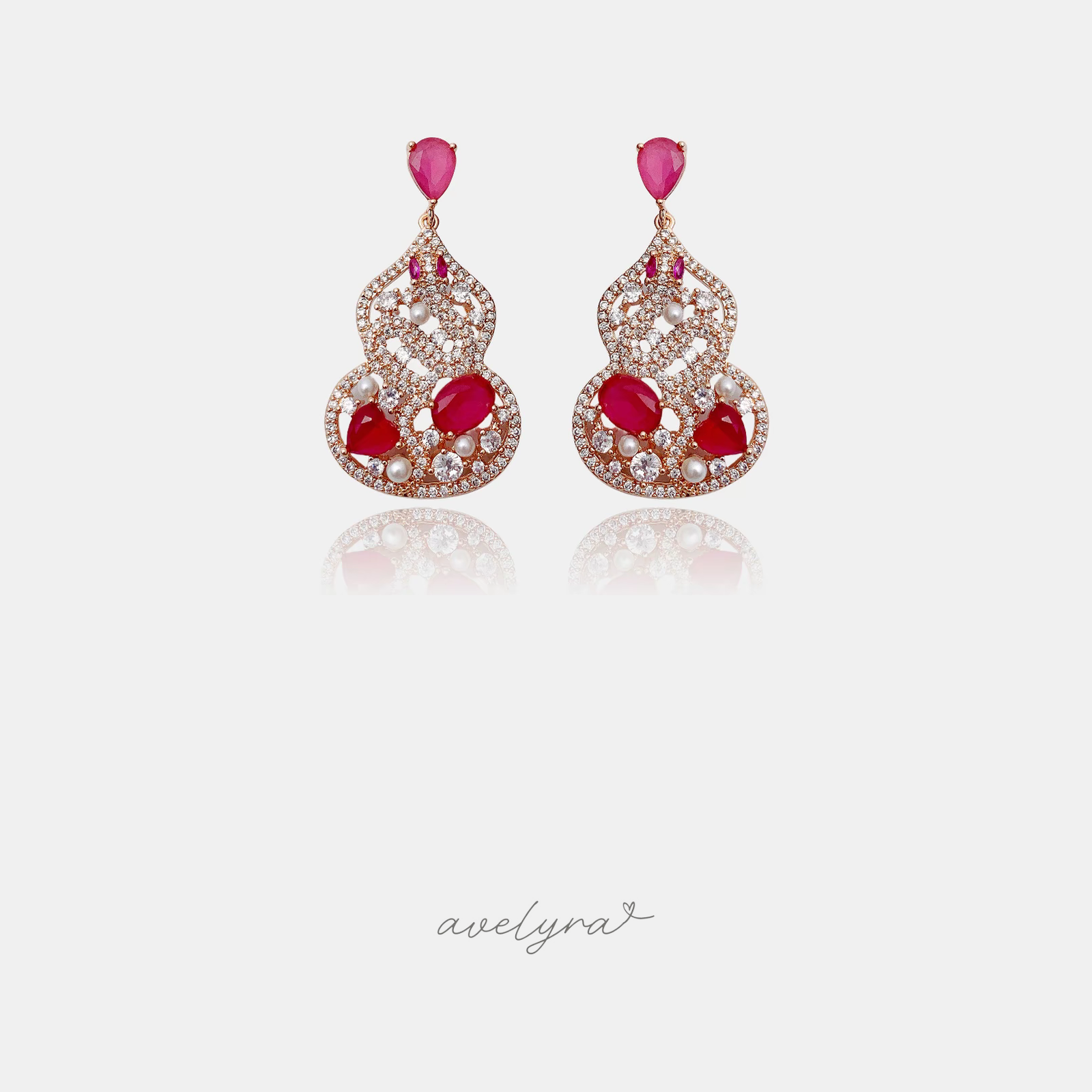 Pair of ornate drop earrings with crimson and pink stones, small pearls and pave scrollwork.