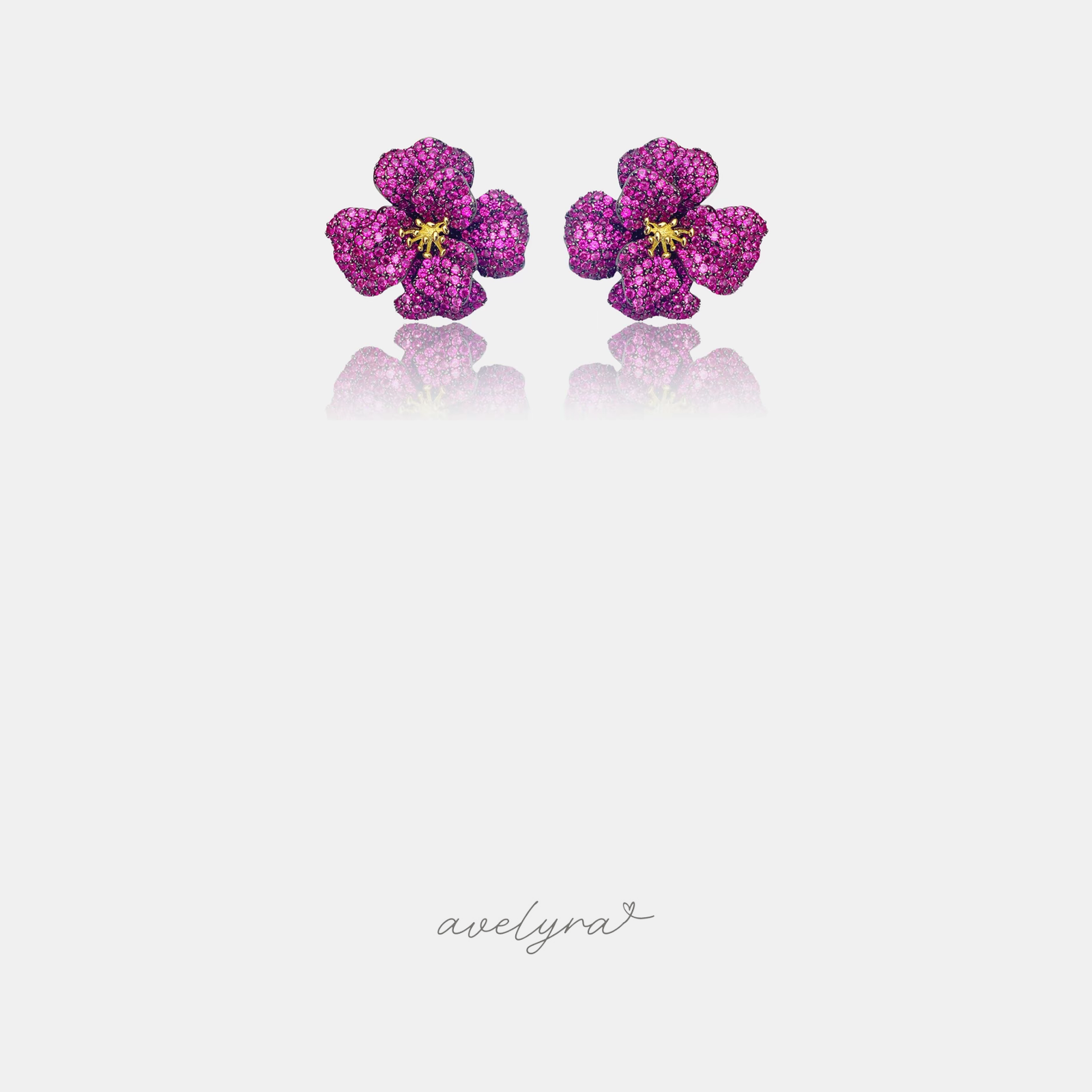 Pair of flower stud earrings densely pave-set in fuchsia pink with a small gold centre.
