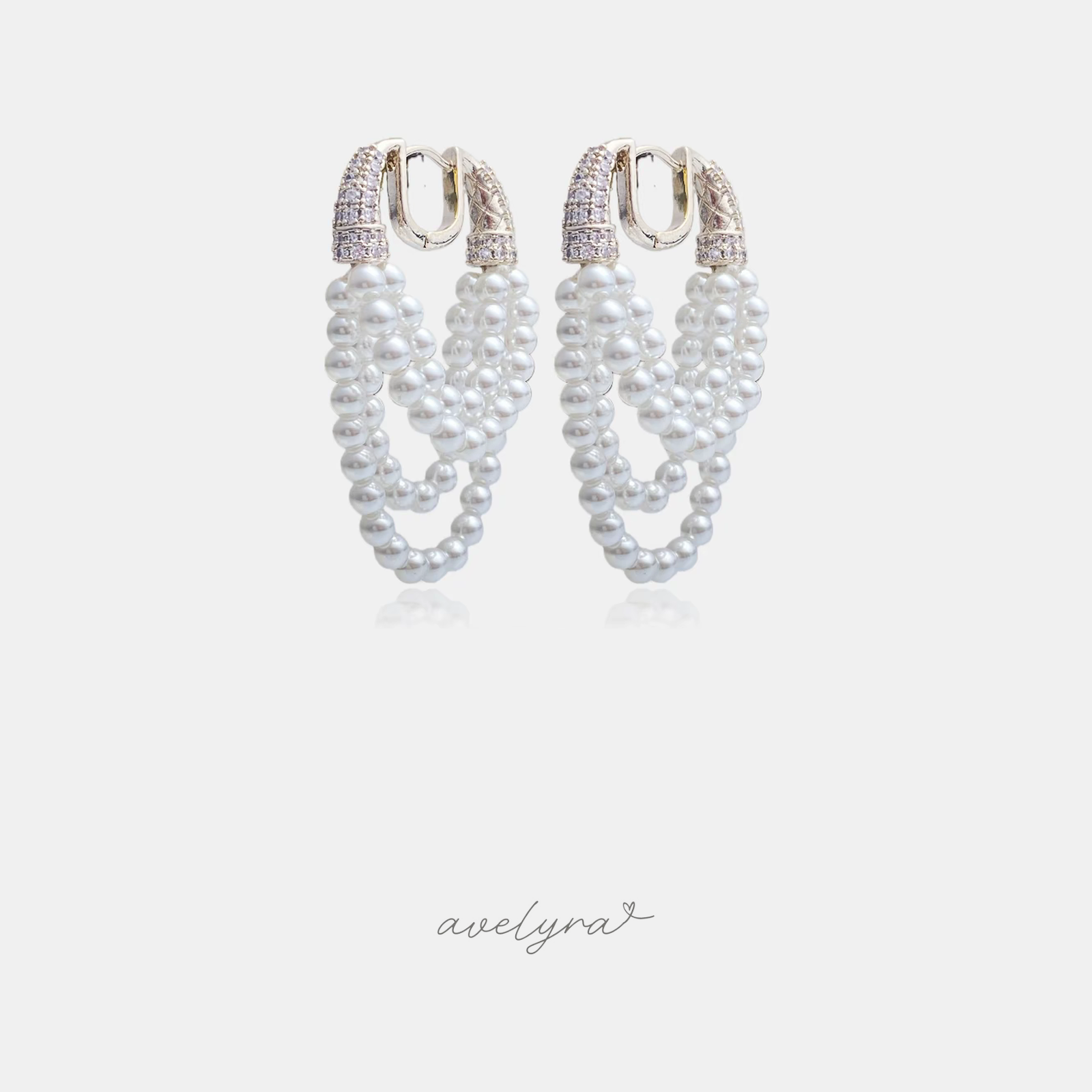 Pair of hoop earrings formed from rows of white pearls with a pave crystal upper section.