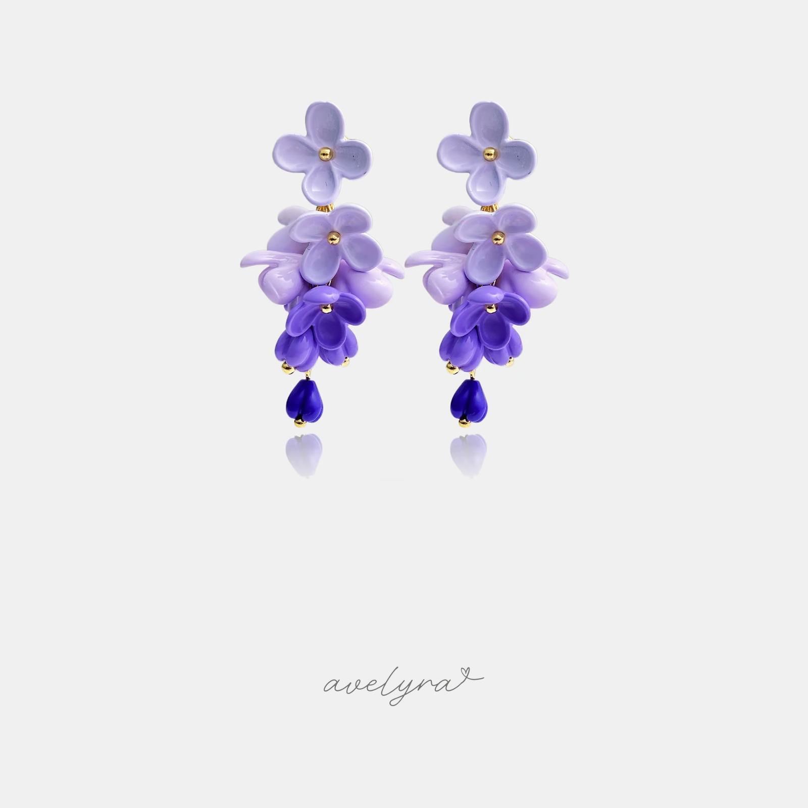 Dangle earrings made of layered lilac and violet flower petals ending in a deep blue-purple teardrop bead.