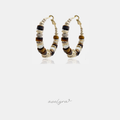 Gold-tone hoop earrings strung with brown stone disc beads and pale pearl accents.