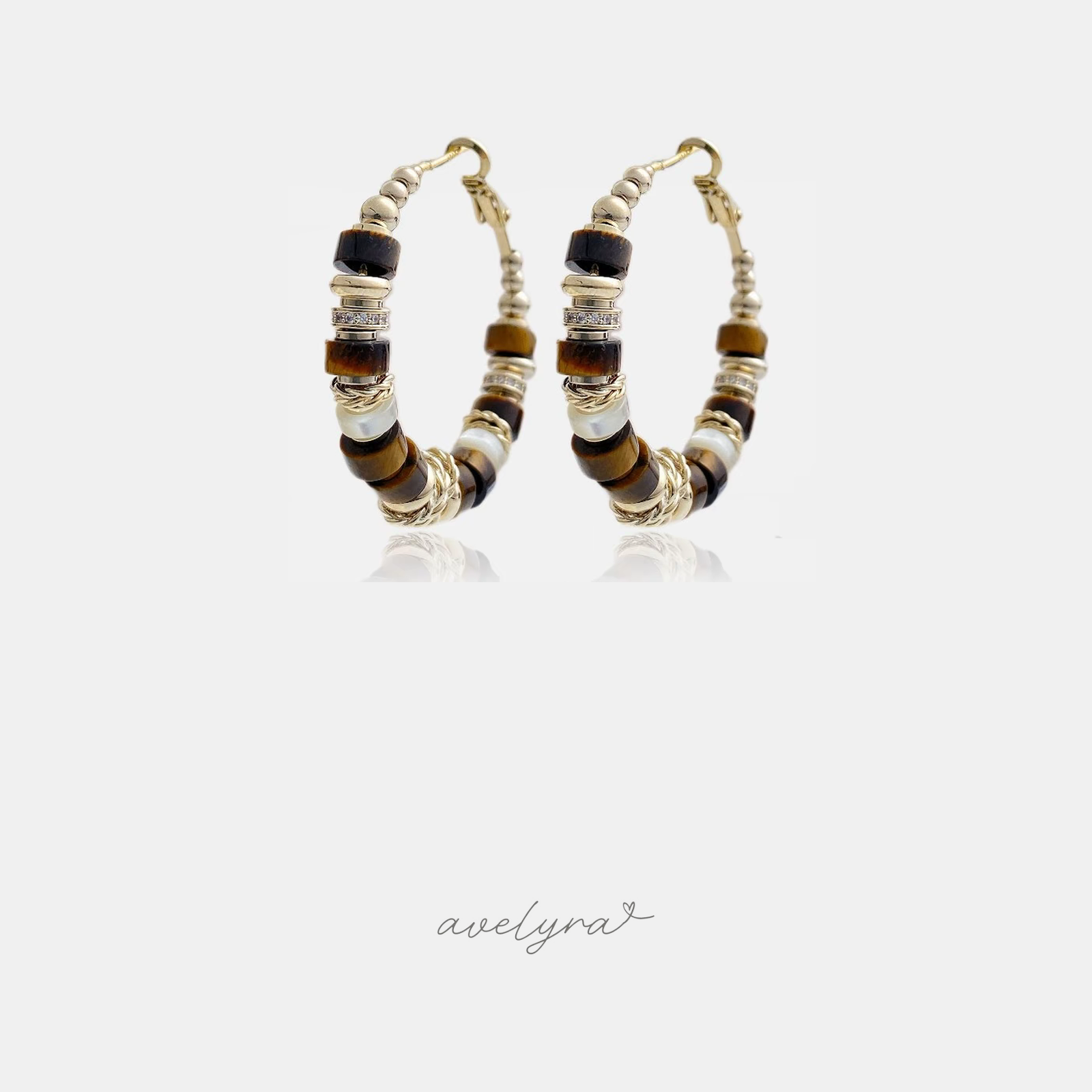 Gold-tone hoop earrings strung with brown stone disc beads and pale pearl accents.