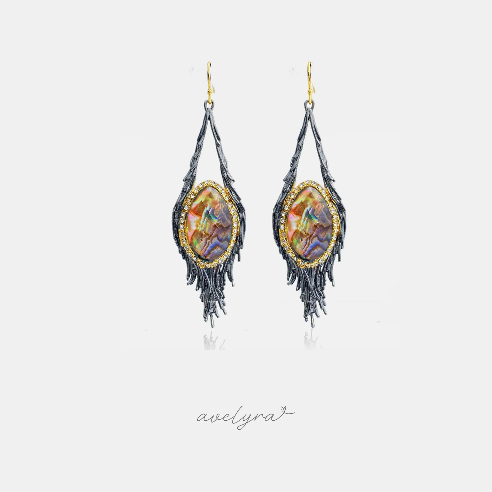 Dark feather-shaped dangle earrings with fringe and a central iridescent stone edged in clear crystals.