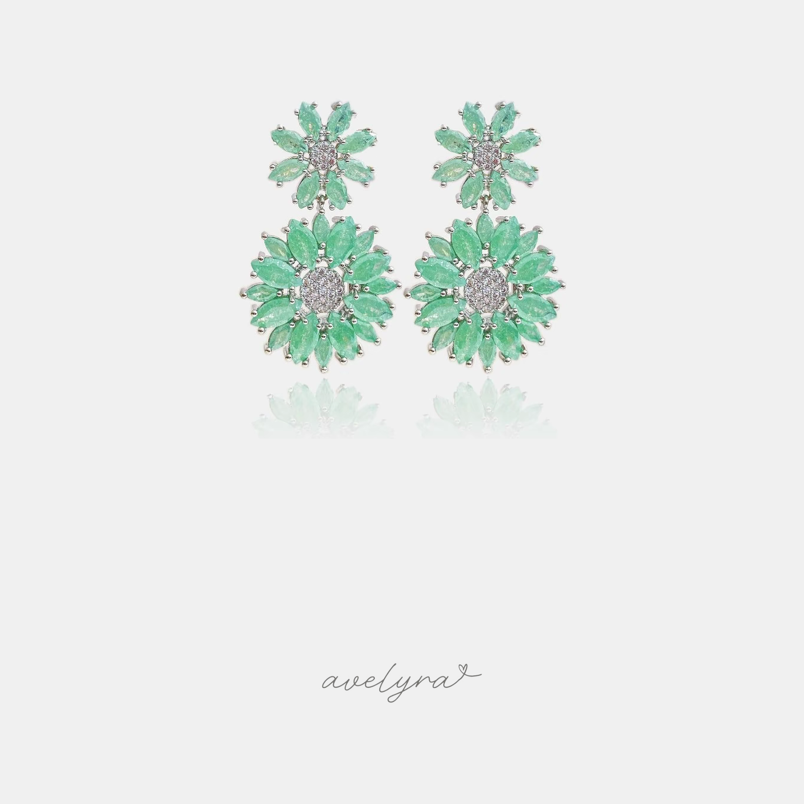Silver-tone drop earrings with two mint-green marquise-cut flowers around pave centers.