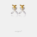 Stud earrings with sculpted gold and white ivory petals shaped like a flower.