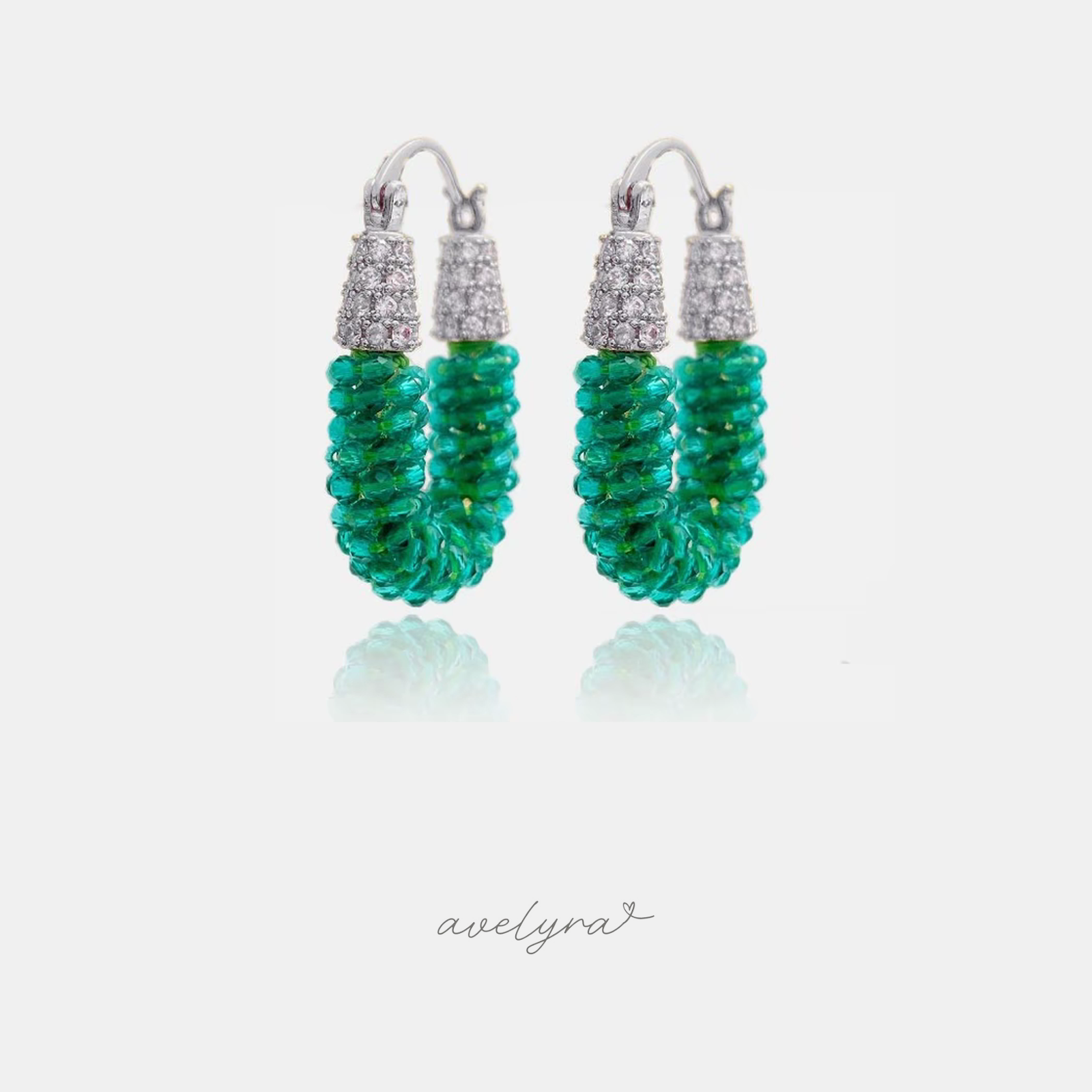 Silver-tone hoop earrings wrapped in coiled teal-green faceted beads with pave tops.