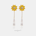 Gold-tone earrings with a yellow sunflower and a long clear faceted teardrop on a chain.
