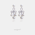 Silver-tone chandelier earrings with a pave bow and a cluster of white pearls.