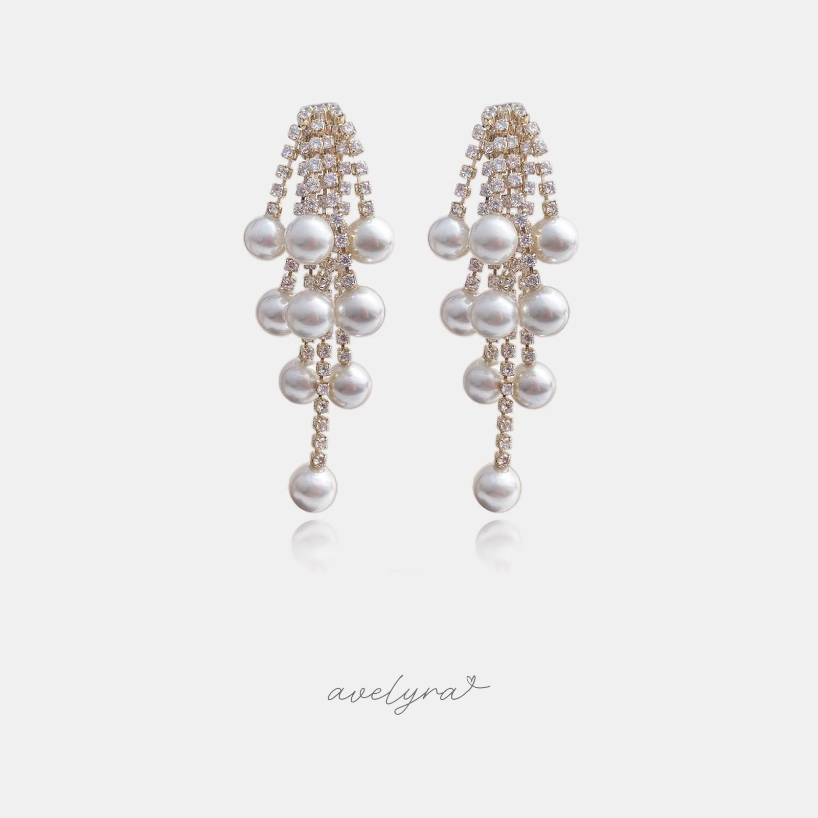 Long drop earrings with cascading white pearls set among sparkling crystal strands.