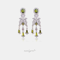 Silver-tone chandelier earrings with olive-green oval and drop stones set among clear crystals.