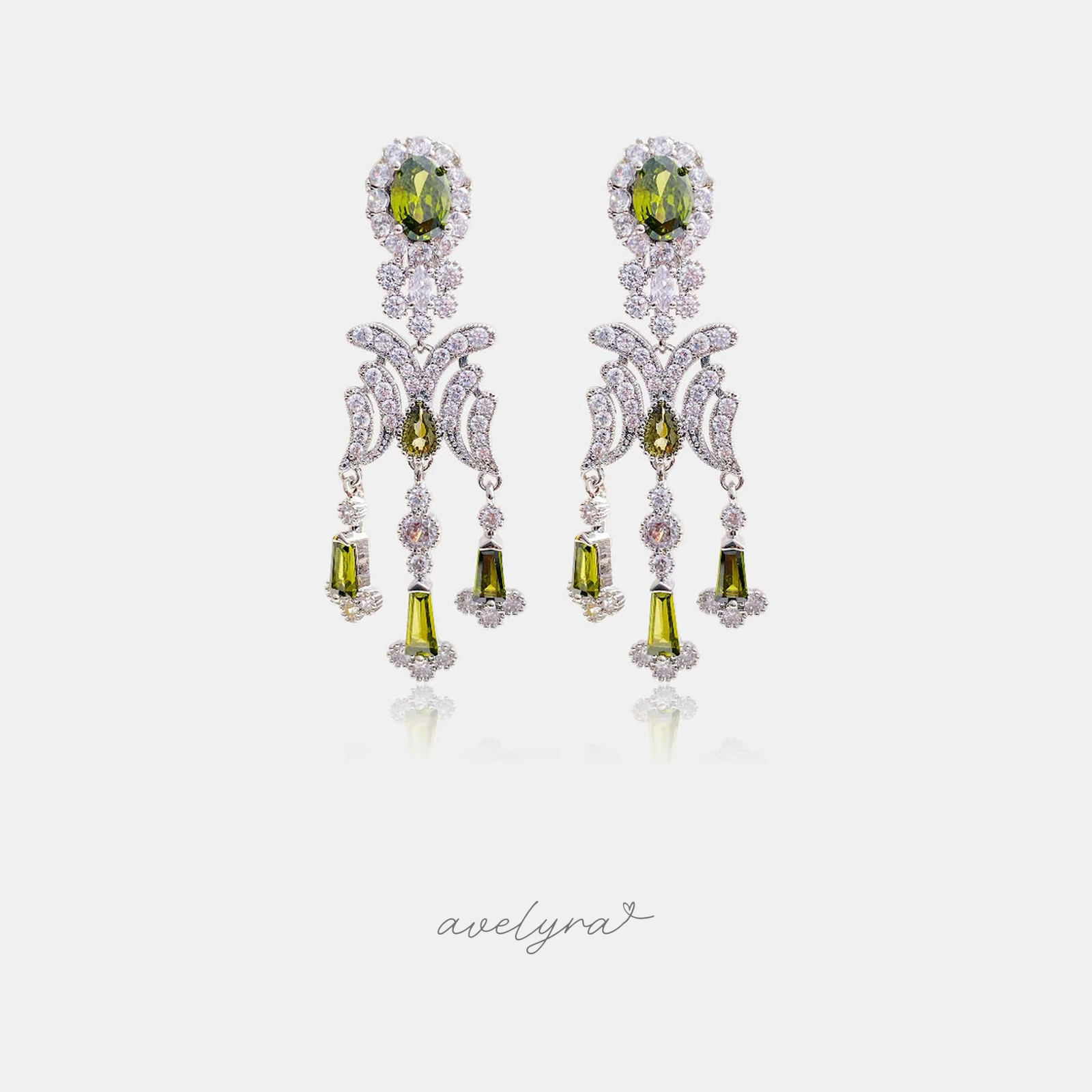 Silver-tone chandelier earrings with olive-green oval and drop stones set among clear crystals.