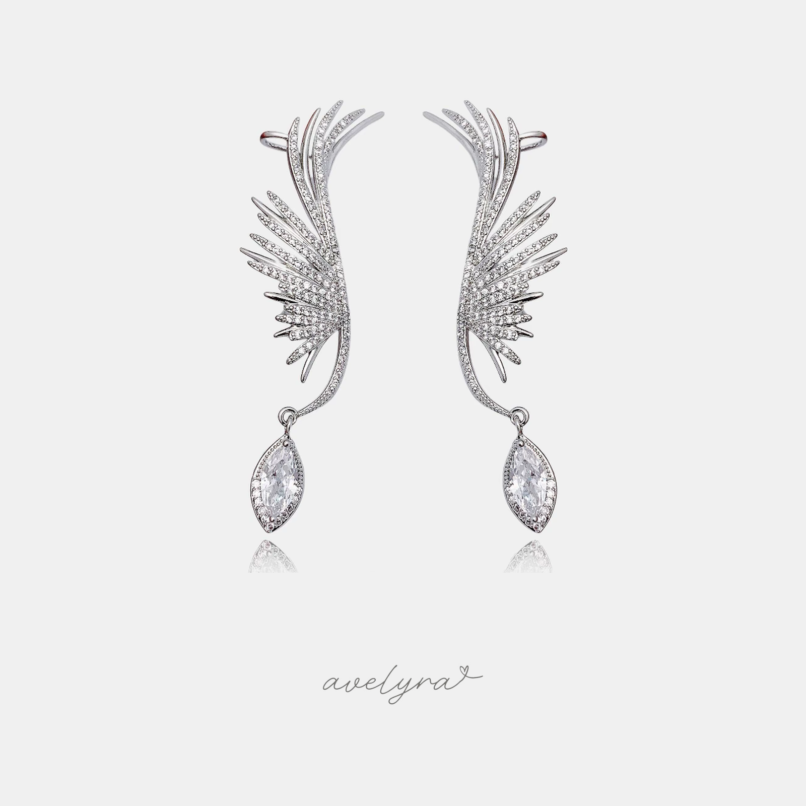 Silver-tone wing-shaped ear climbers covered in crystals with a marquise crystal drop.