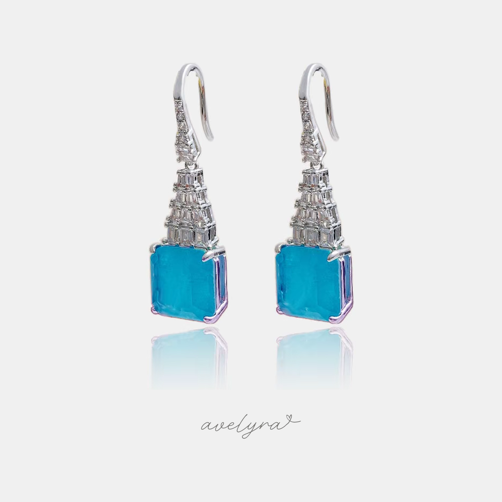 Silver-tone hook earrings with aqua-blue square stones and baguette crystal columns.