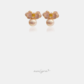 Pink pavé flower earrings with a golden centre stone above a rounded pearl.