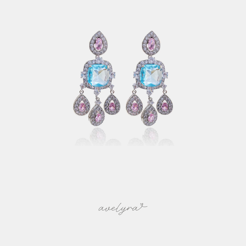 Silver-tone chandelier earrings with an aqua-blue cushion stone, pink accents, and three teardrop drops.
