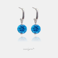 Pair of silver-tone drop earrings with a polished curved top suspending a single round blue faceted stone.