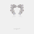 Silver-tone bow-shaped earrings covered in small clear stones with larger clear pear-cut stones along the sides.