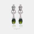 Silver-tone art-deco style drop earrings with clear stones cascading to a large deep-green oval stone.