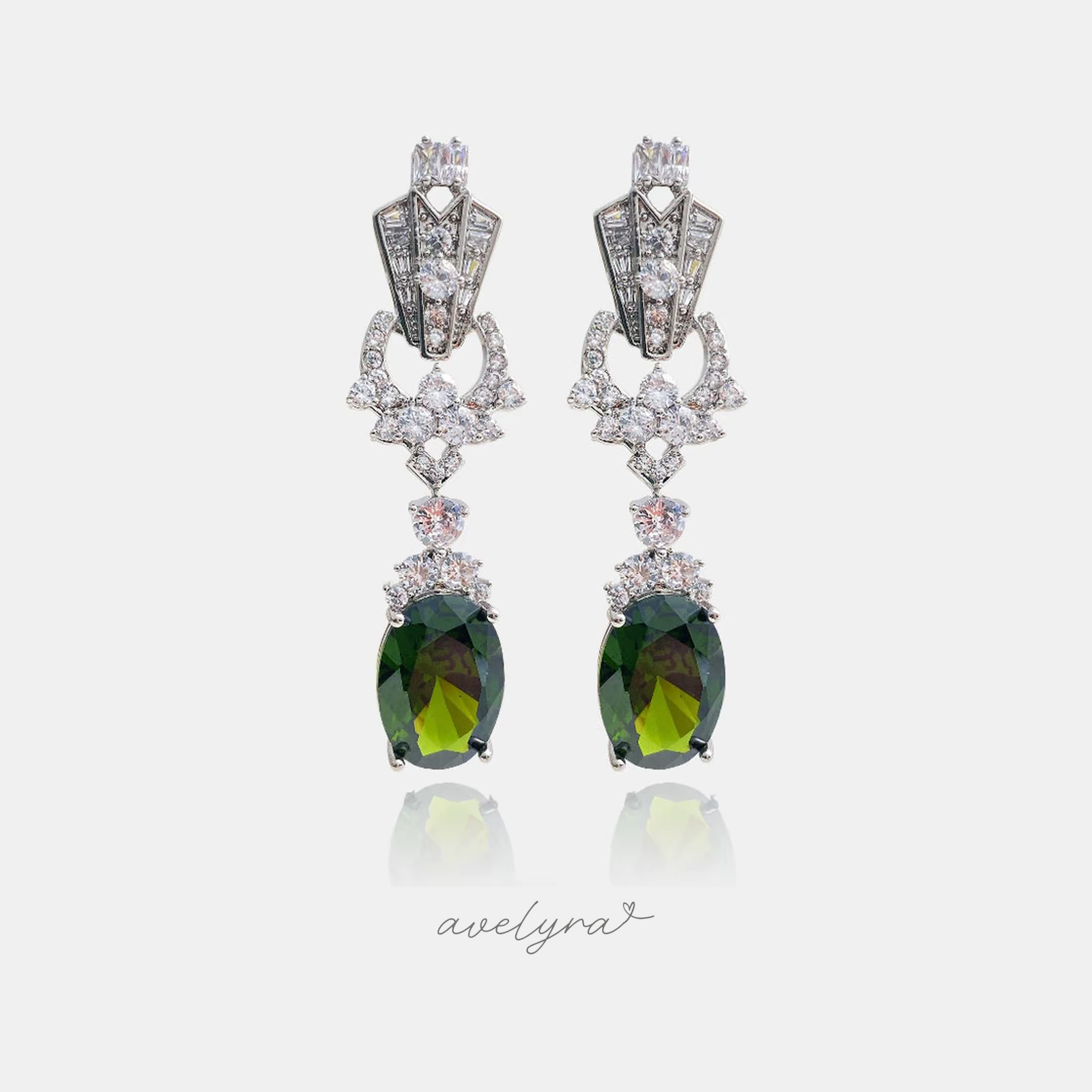 Silver-tone art-deco style drop earrings with clear stones cascading to a large deep-green oval stone.