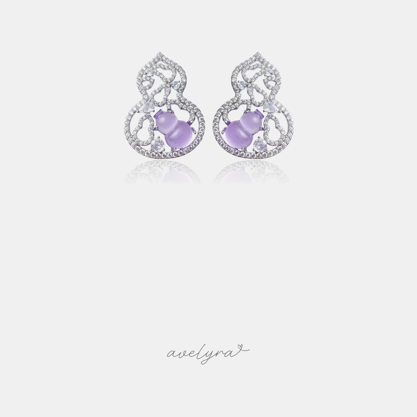 Silver-tone openwork stud earrings with lilac gourd-shaped stones and clear pave accents.