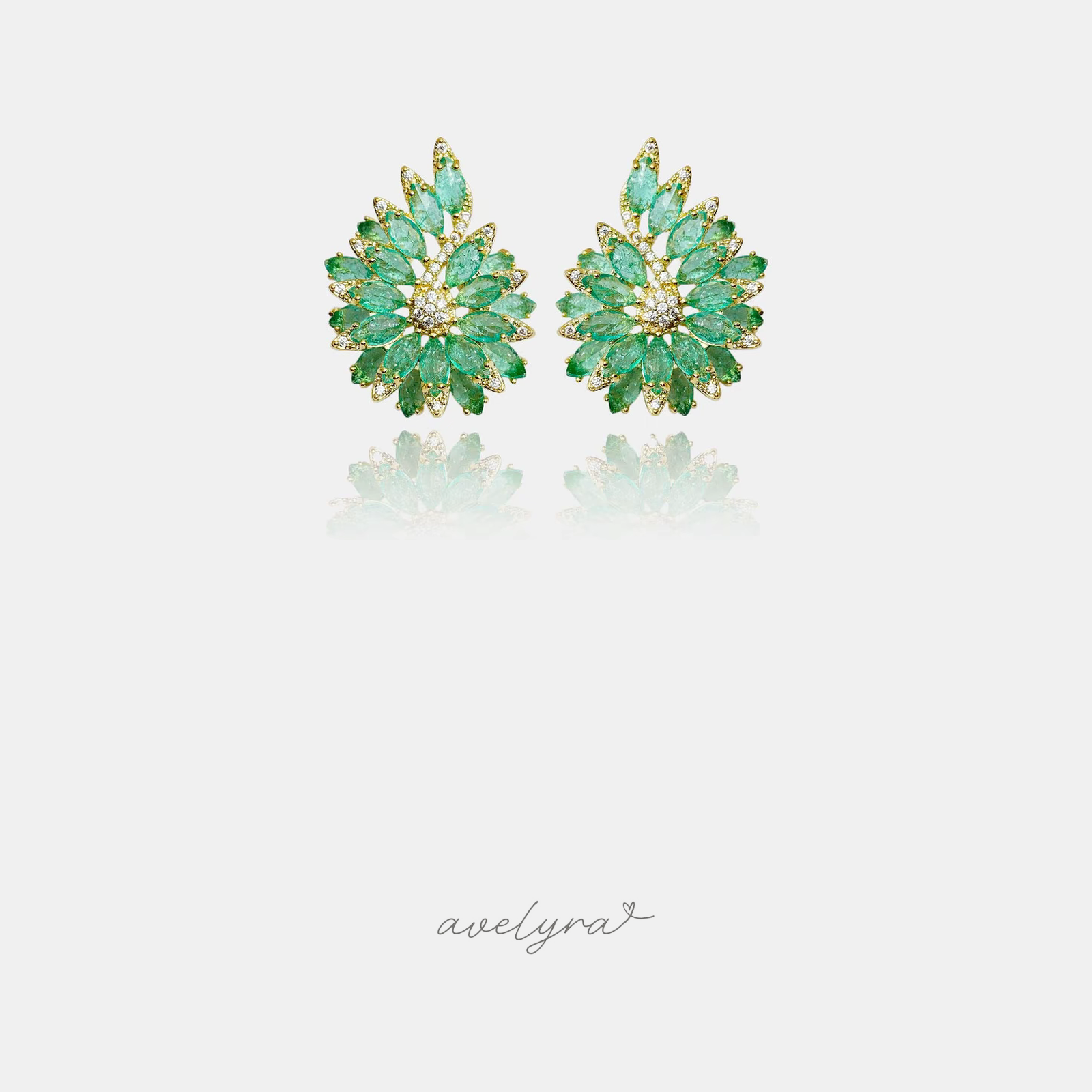 Gold-tone fan-shaped cluster stud earrings set with green marquise stones and clear crystals.
