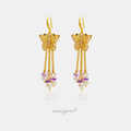 Gold-tone butterfly hook earrings with cascading chains of pearls and violet stone chips.