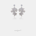Silver-tone drop earrings with a crystal stud and fully crystal-paved wavy leaf shapes.
