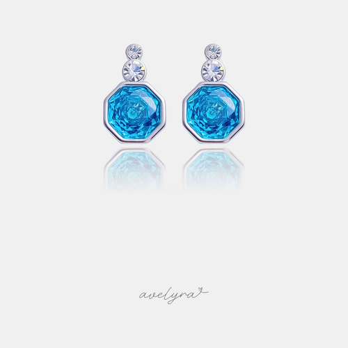 Silver-tone drop earrings with blue octagonal stone and two clear round crystals above.